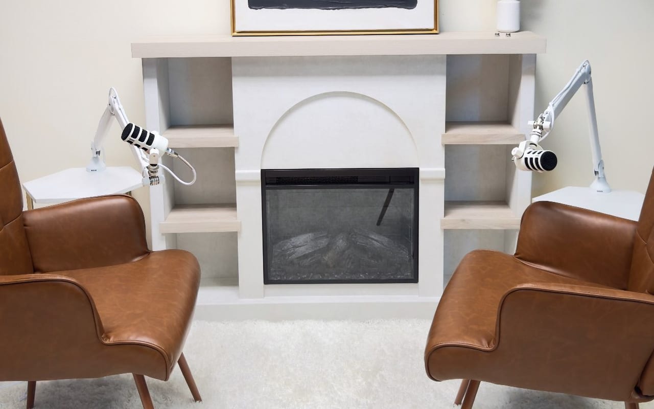 The Hearth: two brown armchairs facing each other beside a fireplace in a bright room